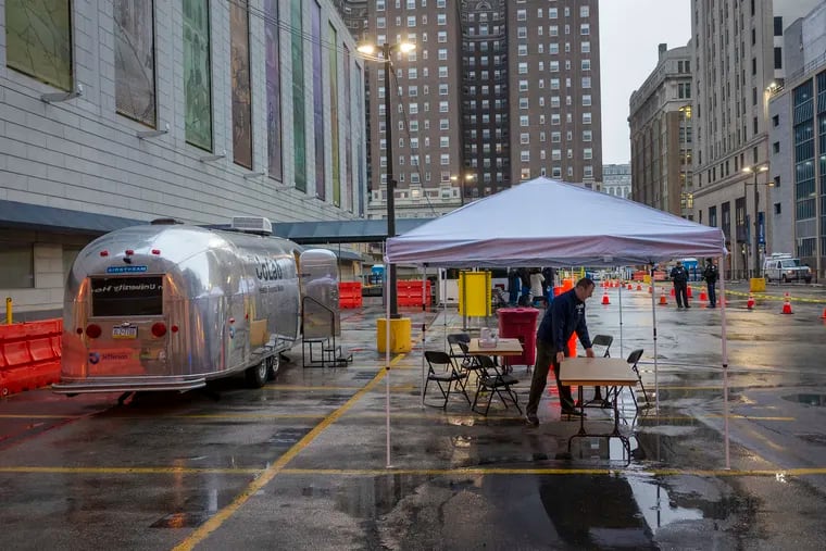 Medical personal set up a makeshift COVID-19 test site in parking lot located at 10th and Sansom St. across from Jefferson Hospital on Tuesday morning March 17, 2020. Hospitals need to rethink how they contribute to communities, writes physician Priya Mammen.