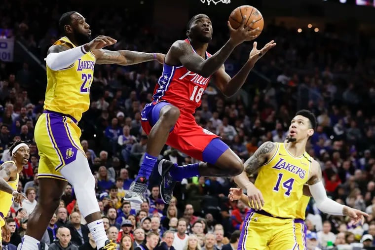 Sixers guard Shake Milton lays-up the basketball past Los Angeles Lakers forward LeBron James and guard Danny Green during the first-quarter on Saturday, January 25, 2020 in Philadelphia.