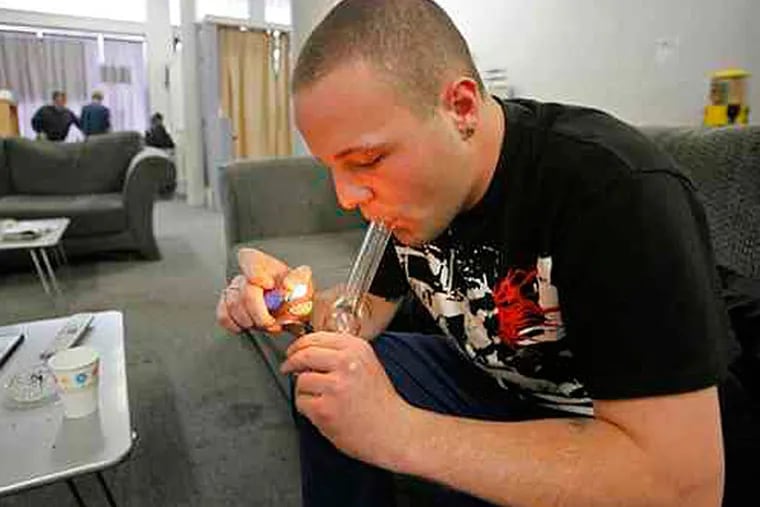 2009 File photo: Samuel Bagdorf of San Francisco lighting a marijuana pipe yesterday at a medical-marijuana clinic in that city.