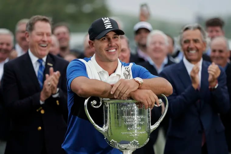 Brooks Koepka poses with the Wanamaker Trophy after winning the 2019 PGA Championship last May. This year's tournament was postponed Tuesday, joining the Masters on the list of professional golf's delayed majors.