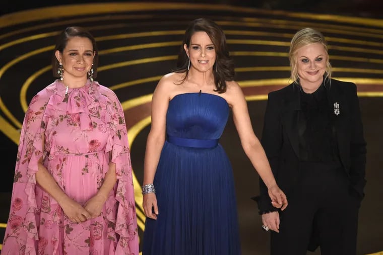 Maya Rudolph, from left, Tina Fey and Amy Poehler present the award for best performance by an actress in a supporting role at the Oscars on Sunday, Feb. 24, 2019, at the Dolby Theatre in Los Angeles.