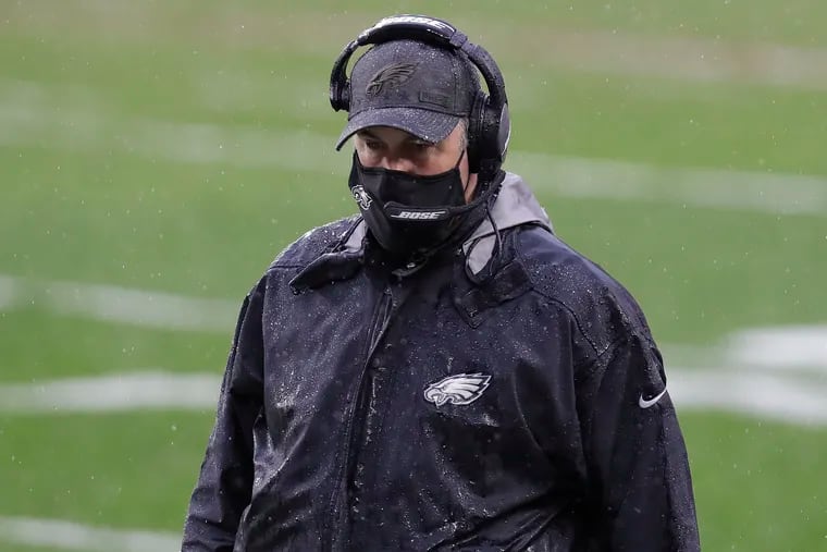 Eagles coach Doug Pederson on the rain-soaked sideline in Cleveland looks down during the third quarter against the Cleveland Browns on Sunday, November 22, 2020.