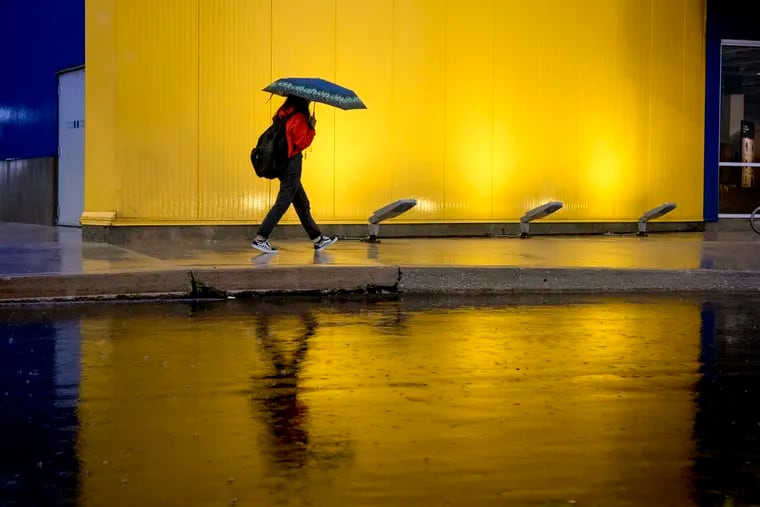 A shopper heads to the front door the Ikea in the rain in South Philadelphia October 16, 2019.