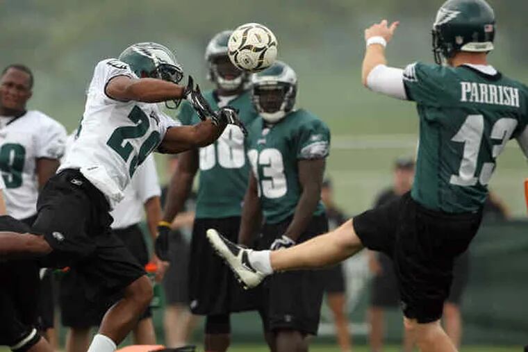 Eagles safety Nate Allen blocks a soccer ball punted by Ken Parrish during a special-teams drill on Thursday.