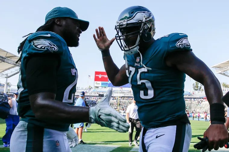 Eagles running back LeGarrette Blount and defensive end Vinny Curry celebrate their 26-24 win over the Los Angeles Chargers on Sunday.