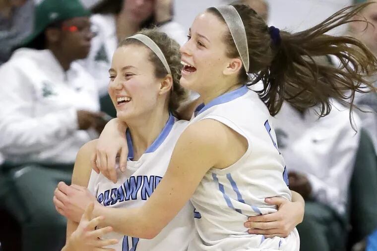 Shawnee’ Erica Barr (left) and Cameron Morgan celebrate after Barr’s game-winning shot.