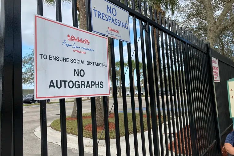 Signs are posted outside the gates to Roger Dean Stadium in Jupiter, Fla., where officials from Major League Baseball and the Players Association are holding meetings to negotiate a new collective bargaining agreement that would end a three-month lockout.