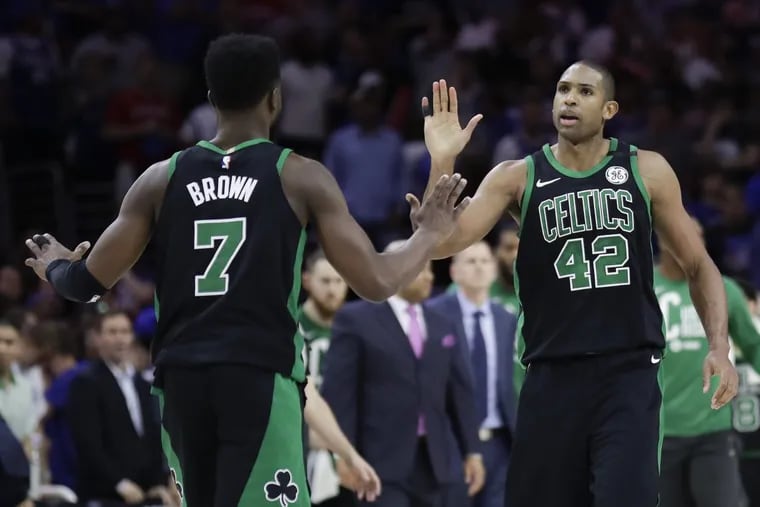 Celtics forward Al Horford (right) celebrates with teammate Jaylen Brown after Horford hit a late shot in overtime against the Sixers on Saturday in Philadelphia.
