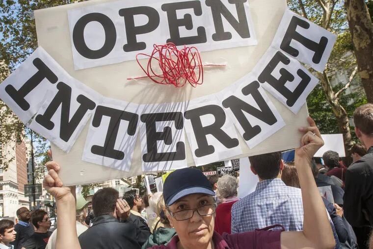 Activists protest outside of New York City Hall in September 2014 to demand protections for net neutrality.