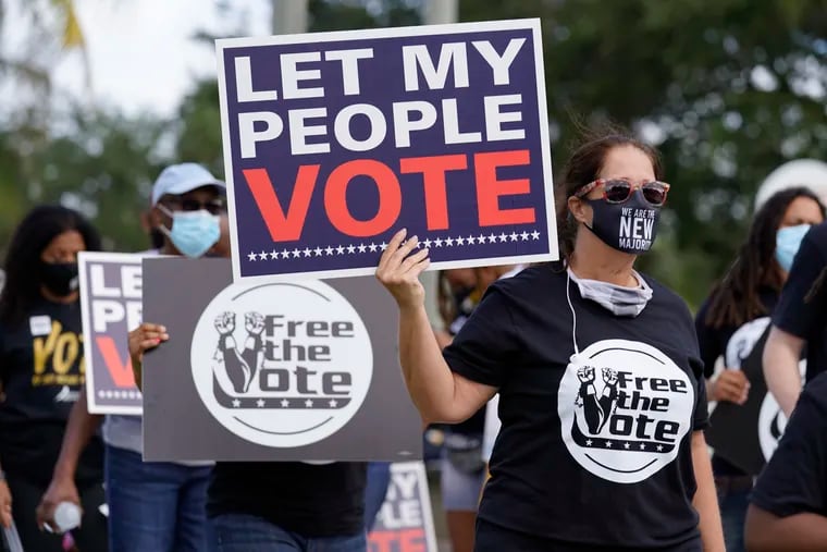 Supporters of restoring Florida felons' voting rights march to an early voting precinct in October in Fort Lauderdale. The Florida Rights Restoration Coalition led marches to the polls in dozens of Florida counties.