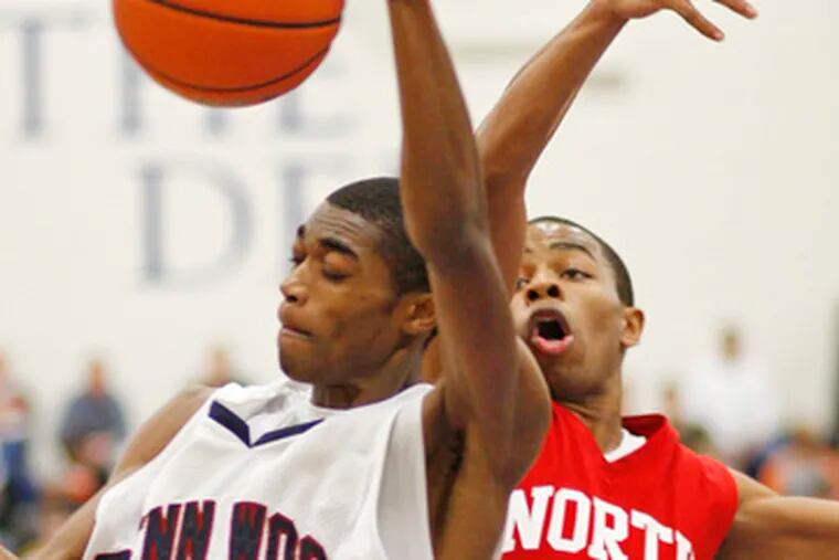 Penn Wood&#0039;s Duane Johnson (left) wins the rebound in a duel with North Catholic&#0039;s Jaleel Mack. Johnson scored 8 points.
