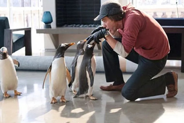 Jim Carrey as Tom Popper with his Antarctic arrivals. Popper is an obsessed executive whose life is changed by the penguins.