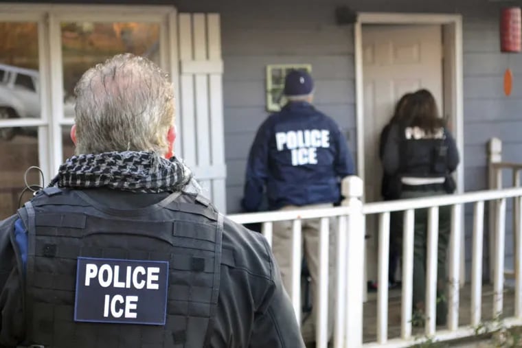 In this Feb. 9, 2017, photo provided by U.S. Immigration and Customs Enforcement, ICE agents appear at a home in Atlanta, during a targeted enforcement operation.
