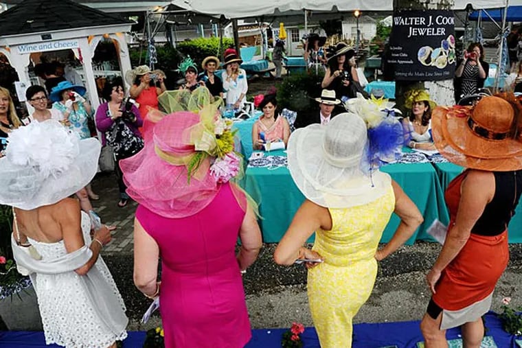 Posing for the judges in the annual hat contest are The Seasons. They won in the Best Hat-to-Toe category. ( CLEM MURRAY /
Staff Photographer )