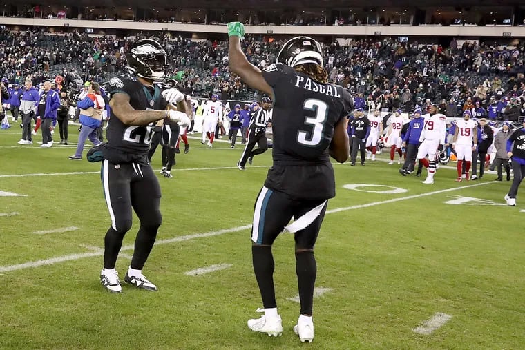 Philadelphia Eagles running back Miles Sanders (left) and wide receiver Zach Pascal (right) dance on the field after the Eagles win 22-16 over the Giants at Lincoln Financial Field on Sunday, Jan. 8, 2023, in Philadelphia, PA.  The win secured the top seed for the Eagles in the NFC playoffs.