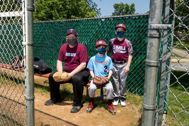 Stephen Silver and his sons Jonah Silver, 8, and Noah Silver, 10, posed for a portrait at the South Marple Little League fields in Broomall.
