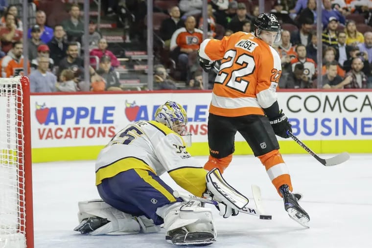 Nashville Predators goalie Pekka Rinne stops the puck in front of Flyers right wing Dale Weise during a second-period power play on Thursday.