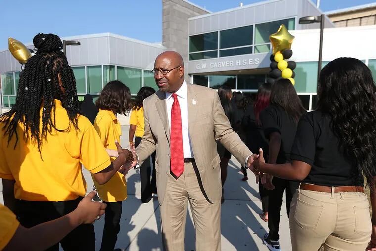 Mayor Michael Nutter, center, greets students as the walk into at Carver High School of Engineering and Science for the first day of classes in Philadelphia, PA on September 8, 2015. ( DAVID MAIALETTI / Staff Photographer )