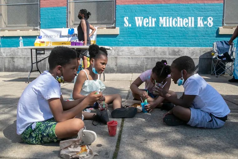 Kids from Mitchell Elementary enjoy water ice while families and community members gathered for a rally against gun violence in Southwest Philadelphia. A shooting happened in broad daylight outside the school earlier this month, and some families are now afraid to send their children to school.