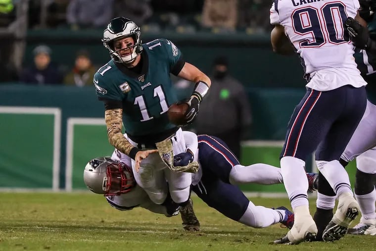 Eagles quarterback Carson Wentz is sacked by New England Patriots middle linebacker Kyle Van Noy in the 2nd quarter.