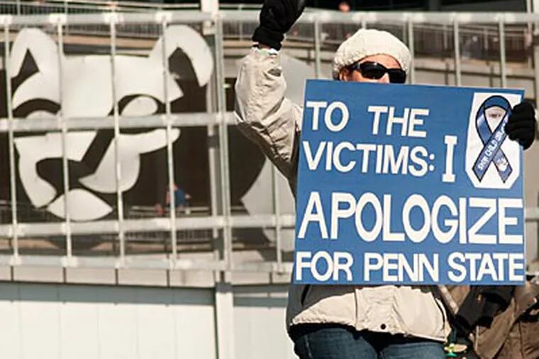 A woman protests outside of Beaver Stadium before Saturday's Penn State game. (Kriston J. Bethel/For the Inquirer)