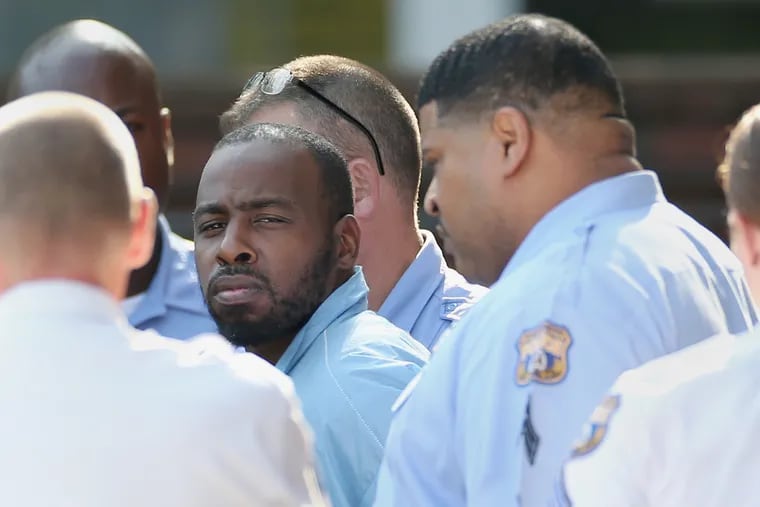 Maurice Hill, who is accused of shooting six police officers during an hours-long standoff Wednesday, is led out of the Philadelphia Police Department 1st District station in South Philadelphia after being arraigned on Saturday, Aug. 17, 2019. Hill surrendered after allegedly barricading himself in a North Philadelphia home for hours and repeatedly firing on officers.