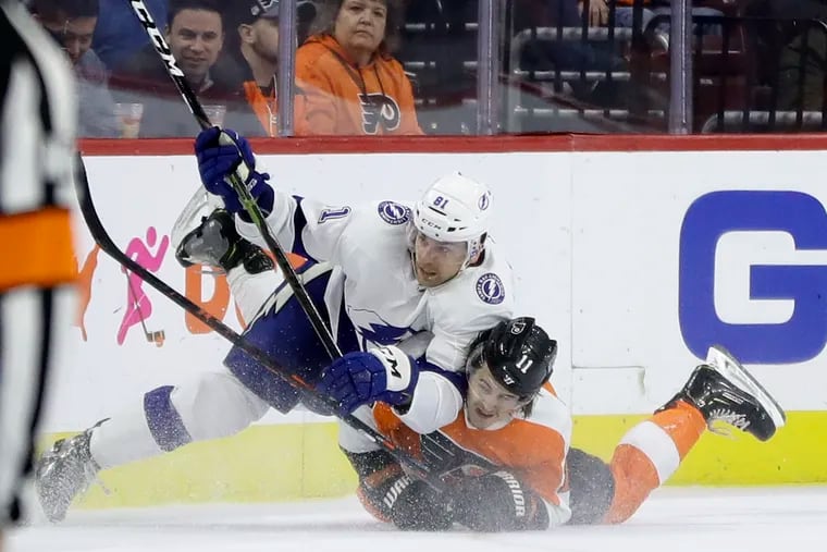 The Lightning's Erik Cernak collides with the Flyers' Travis Konecny (11) during the third period.