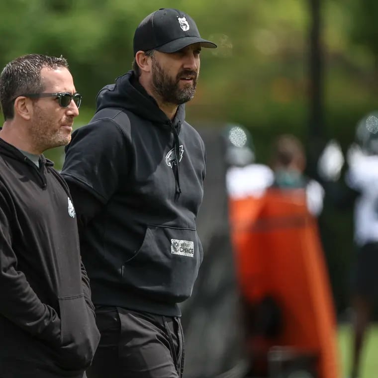 Eagles general manager Howie Roseman, left, and head coach Nick Sirianni look on during rookie minicamp at the NovaCare Complex in May. Roseman is juggling chainsaws this season. Can he handle the pressure?