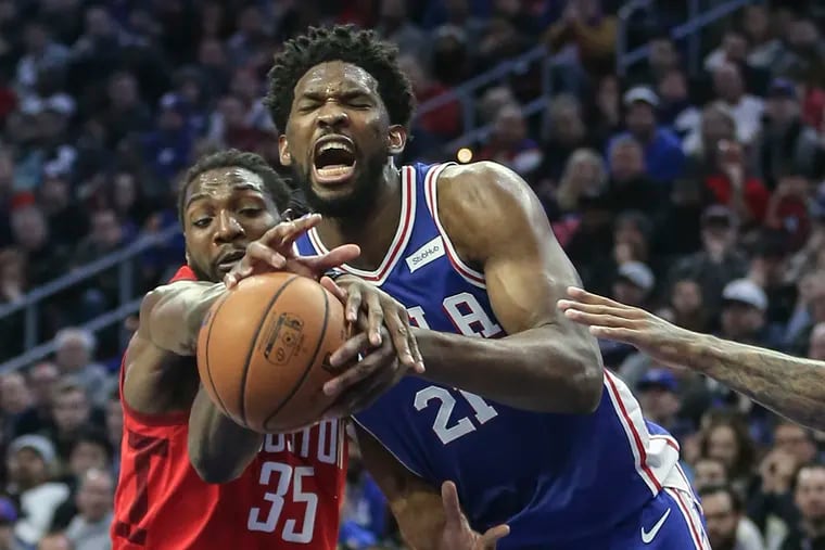 Kenneth Faried (35) fouling Sixers center Joel Embiid during the third quarter Monday.