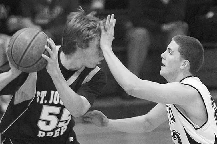 St. Joseph&#0039;s Prep&#0039;s Pete Buzby (left) keeps ball away from Archbishop Ryan&#0039;s Anthony Keiter.