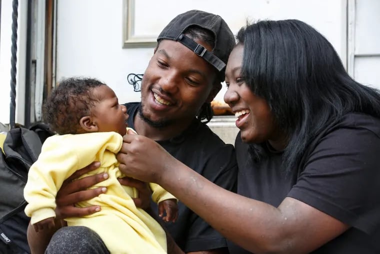 Thomas Brown, 20, and Candea Atkins, 23, with their infant son, Symar, during a meeting with their Safe Start advocate two weeks ago.in West Philadelphia.