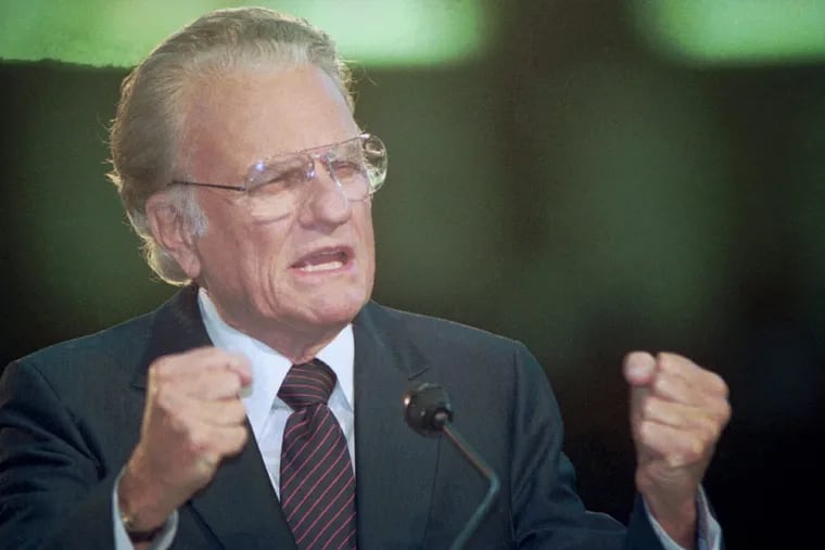 American evangelist Billy Graham gestures to a crowd in Moscow's Olympic arena Oct. 24, 1992. About 30,000 Christians from across the former Soviet Union assembled in Moscow to hear Graham.