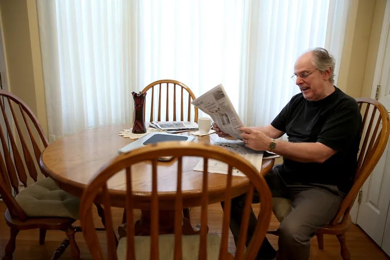 Anthony DeVirgilis reads the newspaper at his home in Sicklerville, NJ on July 6, 2018.  He spent his life selling computer systems, but now worries that technology has begun to tear us apart as a society.