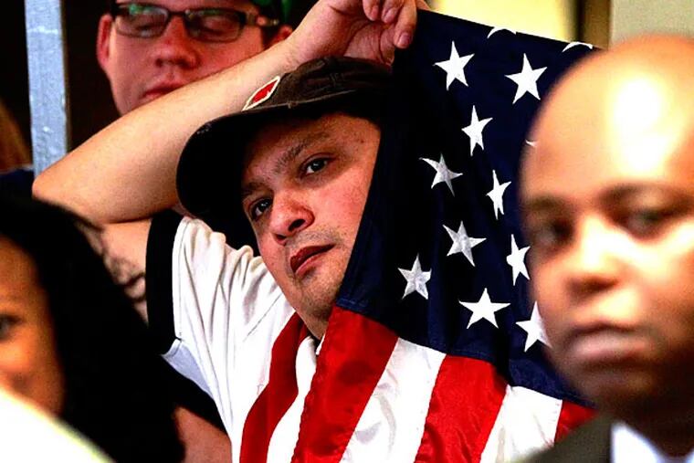 A reader asks columnist Harry Gross: where is the conscience of America when it comes to the poor and unemployed? Here, Democratic supporter Sergio Villarreal  holds an American flag during an event supporting President Barack Obama's health care overhaul on Thursday, June 28, 2012 in Fort Worth, Texas.  (AP Photo/The Fort Worth Star-Telegram, Ron Jenkins/File )