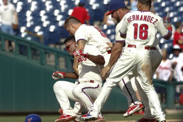 Jonathan Papelbon tackles teammate Odubel Herrera, who delivered the game-winning hit for the Phillies.