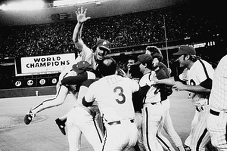 Mike Schmidt leaps into a clutch of celebrating Phillies after the 1980 World Series victory. At right, the trophy is on display in 1981 in Veterans Stadium.