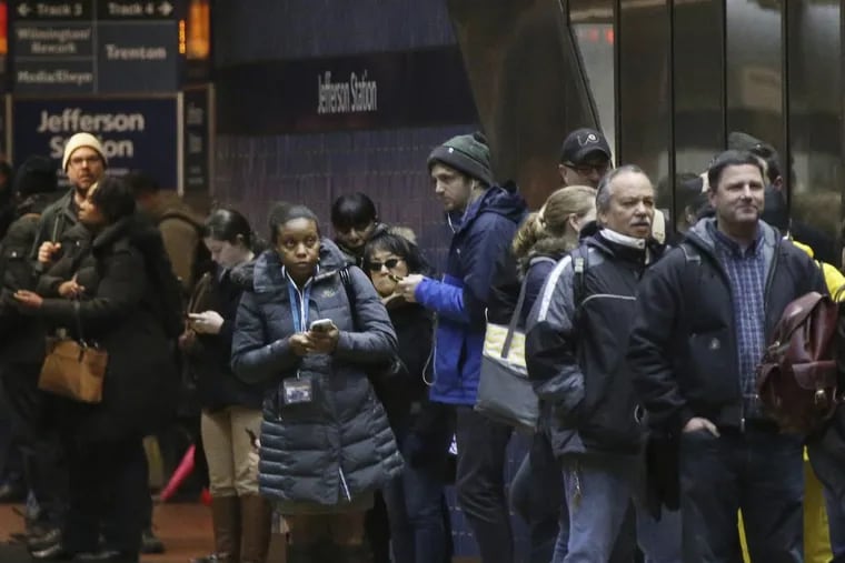 Passengers wait for SEPTA Regional Rail trains, most of which were suspended, in Jefferson Station in Philadelphia, during Friday’s nor’easter.