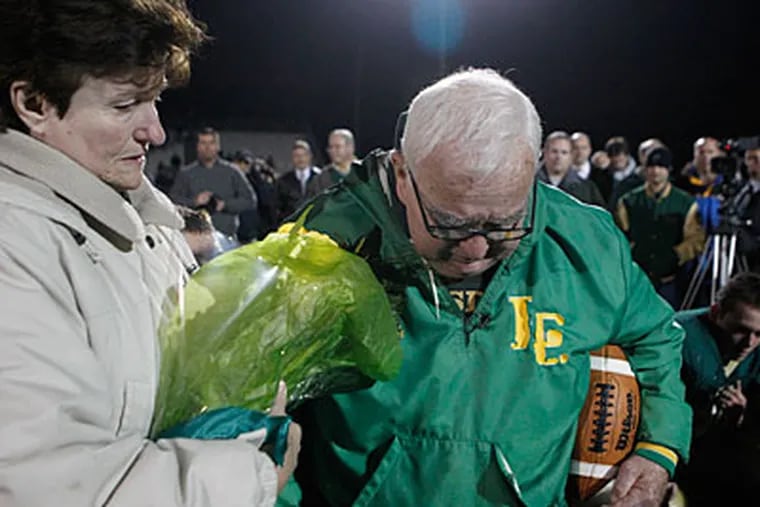 Lansdale Catholic head coach Jim Algeo walks off the field with wife Mandy. (Ron Cortes/Staff Photographer)