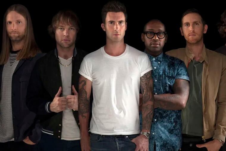 Maroon 5, with front man Adam Levine (white shirt), performed its big, rhythmic pop, with a good deal of reggae in the mix, Monday to a sold-out crowd at the Wells Fargo Center.