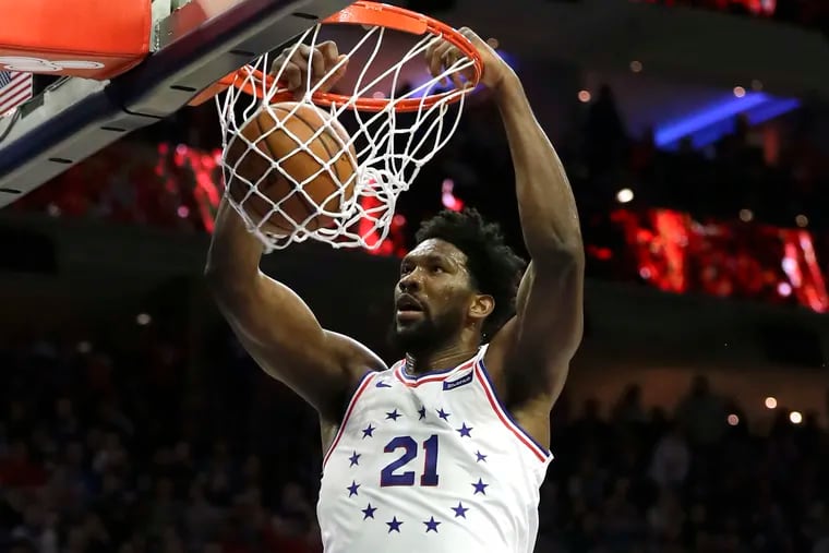 Sixers center Joel Embiid, whom Dr. J says has "The Gene" for winning, dunks against the Lakers.