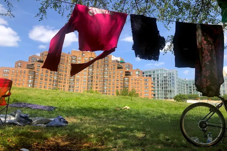 The laundry of Elizabeth Barksdale and Brandon Johnson hangs to dry outside their tent while they live in the homeless encampment on the Ben Franklin Parkway July 16, 2020.