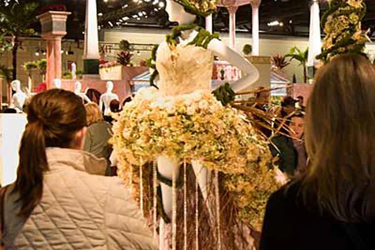 A fantastical floral sculpture attracts attention at the Philadelphia Flower Show. The show is open today, and not crowded, apparently because of the snowy weather. (Ed Hille / Staff Photographer)