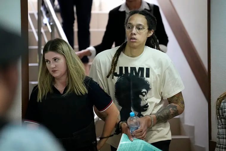 WNBA star and two-time Olympic gold medalist Brittney Griner is escorted to a courtroom for a hearing, in Khimki just outside Moscow, Russia, Friday, July 1, 2022.