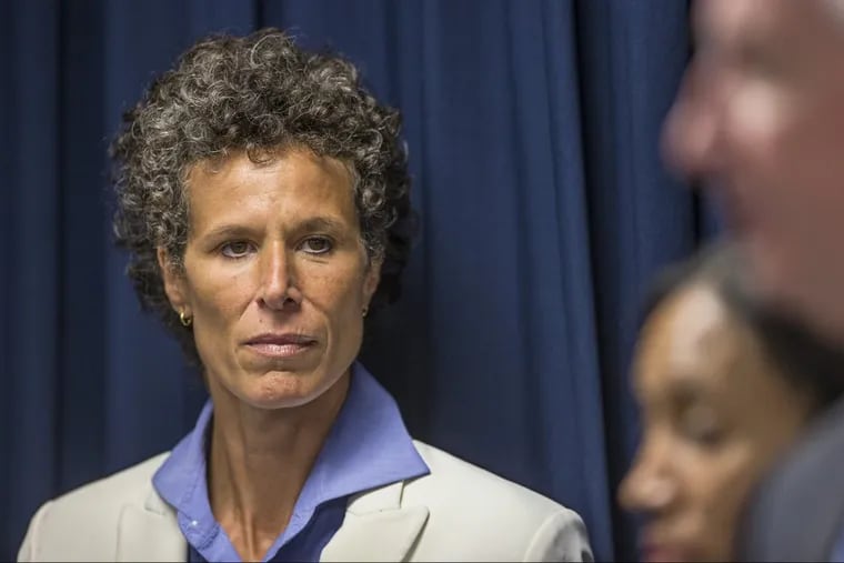 Cosby accuser Andrea Constand, left, listens to Montgomery County District Attorney as he answers questions during the press conference that was held in Norristown after Bill Cosby was found guilty.