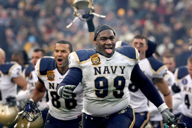 At the end of a 2008 blowout win, Navy's Nate Frazier runs toward fans. The teams meet again Saturday.