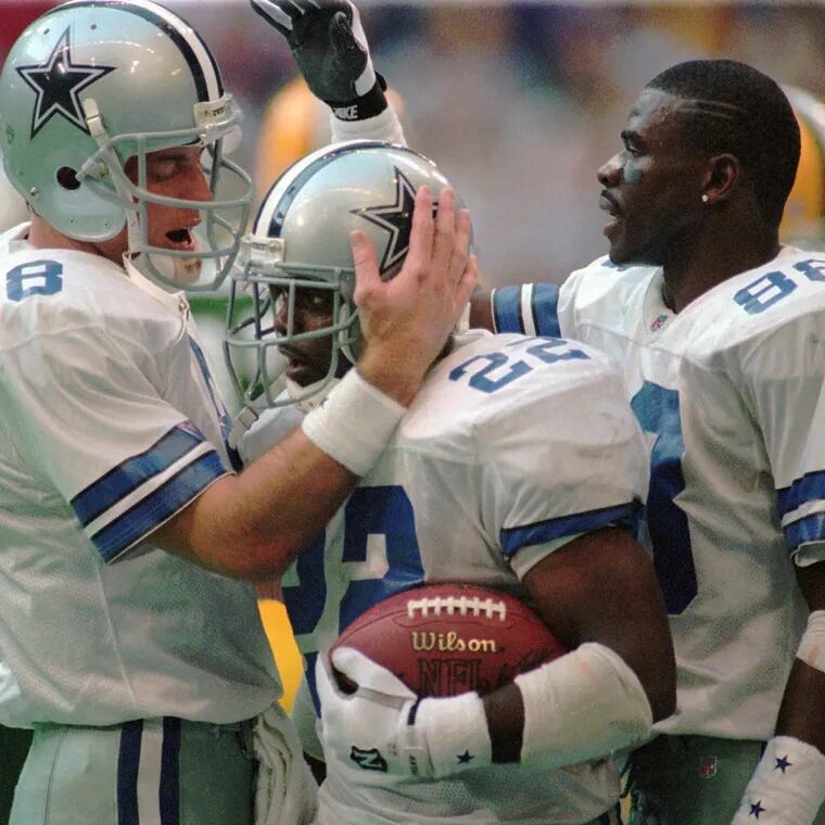 The Cowboys' Hall of Fame trio of Troy Aikman, Emmitt Smith and Michael Irvin celebrate during a victory in 1996.