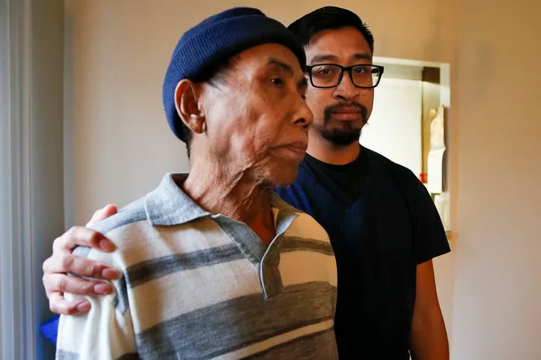 Sophath Chum, 34, (right) with his father Van Chhornn Pheach, 75, in their Southwest Philadelphia home on Friday, November 22, 2019. Chum, a millennial, helps take care of his father.