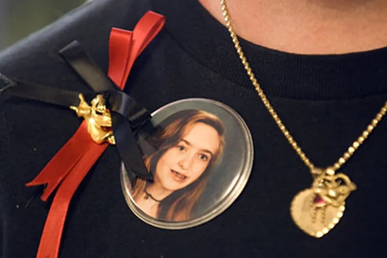 Wendy Lavin wears a photograph of her daughter Jennifer Still who was murdered in 1999. The news that someone is profiting from her child's death, is taking its toll. (Ron Tarver / Staff Photographer)