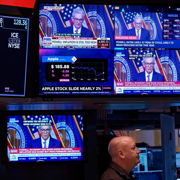Federal Reserve Chair Jerome Powell's speech on Jan. 31 is projected on television screens on the floor of the New York Stock Exchange.