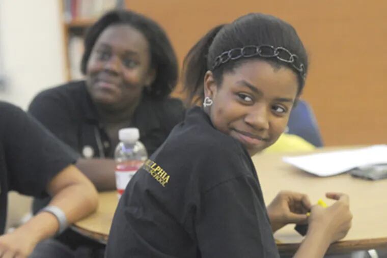 KIPP West Philadelphia students Brianna Phipps (front), 12, and Chanell Johnson, 12, are in the leadership program. (April Saul / Staff Photographer)